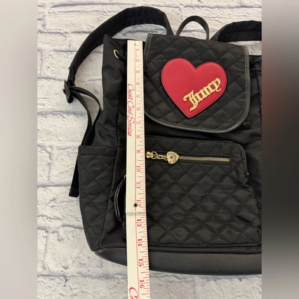 Juicy Couture black quilted backpack heart motif, drawstring top.